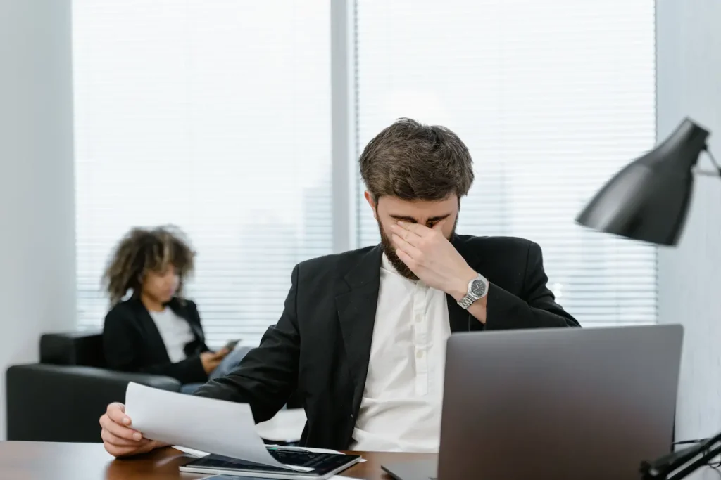 Scène de bureau avec ordinateur portable et lampe, illustration typique des démarches de séparation professionnelle.